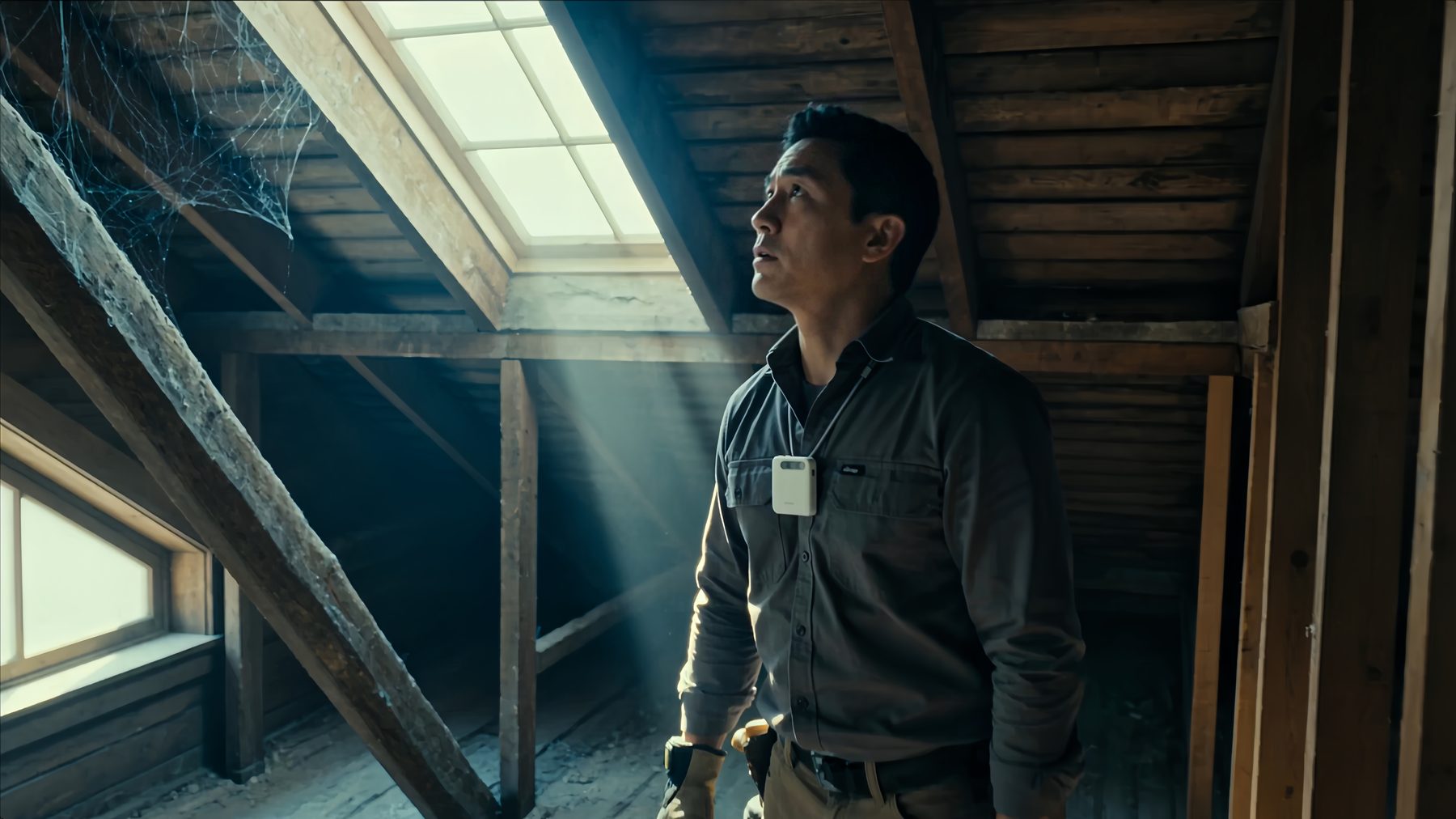 An inspector looking up into a roof space, the A2 Pro worn on his chest